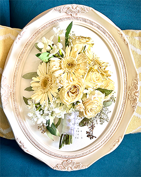 Oval white frame with yellow flowers