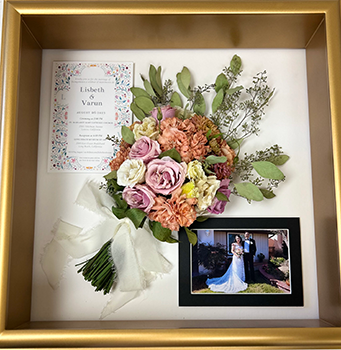 Shadow box gold frame with pink flowers and photo