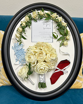 Oval dark gray frame with white flowers